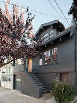 The existing bungalow-style home in San Francisco, California was two stories, with a finished basement and desirable South-facing backyard. Edmonds + Lee Architects preserved the front of the house, painting it black and refinishing the front door to its natural wood tone.