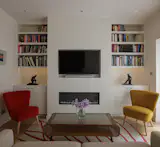 The built-in shelves in the lounge were designed to include art niches for Gail’s sculptures.