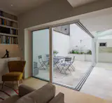 “I just wanted the kitchen to disappear,” says Gail, of the room’s neutral design, which ensures it blends into the flooring and white-painted wall of the courtyard.