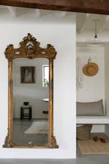 An oversized antique mirror (sourced from friends) bounces light throughout the space.
