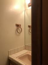 Before: The powder room had the same tile treatment found elsewhere.