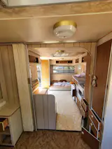 Before: The nook at the end of the caravan was perfect for two bunks for the couple’s children.