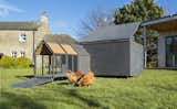 The UK-based firm Raskl Art + Architectural calls this a “luxury minimalist chicken coop.” Materials are Valchromat (Atlantic Plywood) and Iroko wood. The nesting area is denoted by an egg shape perforated into the façade with a CNC machine, and the roof lifts with the help of gas struts.