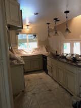 Before: Curtis streamlined the kitchen by removing the upper cabinets, the busy granite counters, and off-the-shelf lighting.