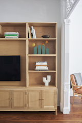 A custom white oak cabinet made by North Summit Studio fits the narrow dimensions of the pass-through television room. “We designed it so that if they ever decided to move, it functions as two credenzas with a series of modular boxes that are dovetailed together and stacked on top of each other. Then you have the one large opening for the television,” says Cuttle. “The thinking was that they could then theoretically very easily repurpose all of that into another residence.”