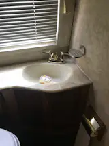 Before: The team retained the angle on the sink vanity counter, and opened up the shower to the room.