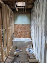 During: The couple removed a too-small linen closet to enlarge the main bathroom. The skylight was happily already in place.