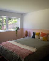 Bedroom, Bed, and Night Stands Color-blocked pink walls echo the stair railing.