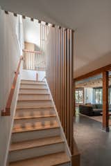 The slatted wall treatment continue downstairs, alongside the powder-coated metal railing. "It has such a good feel in your hand," says Sean.