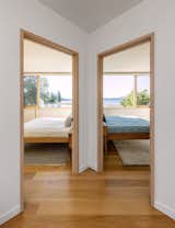 Hallway and Medium Hardwood Floor Thanks to the new dormer, both bedroom suites have views of the waterfront.