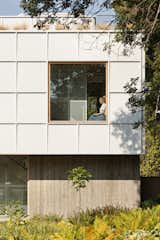 The exterior materials, including board-formed concrete and Hardi Panel, comply with strict building codes that required noncombustible materials in the narrow setbacks. “The exterior cladding to me lay against the house in the same way a record lays against the wall above the stereo,” says Darren.