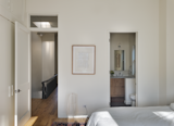 An interior transom window over the bedroom door looks era appropriate and spreads light between rooms. A primary bathroom was added to the right.