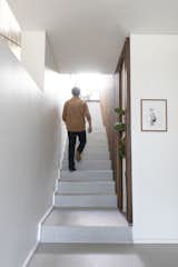 Lotz reoriented the staircase and accented the wall with walnut slats.