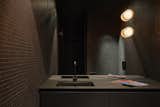 The sink counter in water closet is made from solid Fenix, which was chosen for being more durable than black Corian. “Whenever you scratch black Corian, you see a white scratch in it,” says Béliveau. “So Fenix is way better for dark colors.”