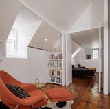 A wide doorway connects the primary bedroom and library, and this view shows how the millwork flows consistently from room to room. The architects also note how they concealed a high performance heat pump system within the newly designed elements of the plan, expanded the exterior wall framing to accommodate higher value insulation and prevent swings in temperature, and introduced new LED lighting throughout.