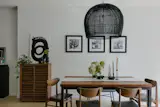 A Buri Bell Large pendant is suspended over the Paulas’ table, surrounded with vintage chairs.
