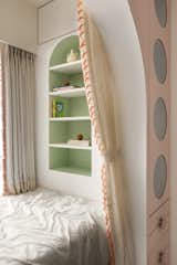 The shelving repeats the arch treatment.