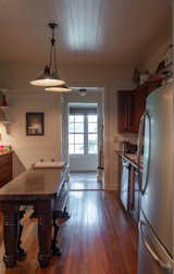 Before: The only dining space in the home was a narrow kitchen island with benches. They also needed to update the structure and systems, as a corner of the house was sinking: “When you opened the refrigerator door, it closed itself,” says Jobe.