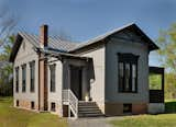 Much of the home’s exterior was preserved. The siding is painted Benjamin Moore “Dolphin,” and the trim is Benjamin Moore “Mopboard Black.”