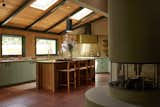 Boy Boy fabricated the framing for the flue shroud and base, which was then finished with plaster, and given a limestone benchtop. The Arto Ceramic tile extends into the kitchen, which has a preserved wood ceiling with new skylights.