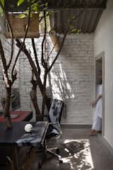 The other side of the room has a second workstation. Curtains can be dropped from the ceiling to protect from the rain coming in through the open aperture.