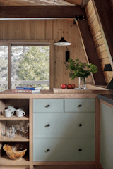 The white oak cabinetry has fronts painted with Weekend Getaway by Benjamin Moore. Cabinets were designed by Emily Kopp and fabricated by JV The New Carpentry.