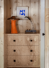 Emily's vintage 1960’s ceramic Arnels mushroom lamp sits atop a custom plywood built-in dresser.