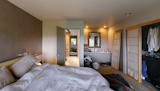 Before: A door led to a hallway with the spiral staircase, while the bathroom was separated into a vanity, and toilet and shower combo behind a door to the right.