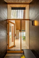 Doors, Swing Door Type, Wood, and Exterior The couple worked with Seattle firm SHED Architecture and Design on a remodel that opened the floor plan and brought in more light. At the front door the glass clerestory and sidelight were kept, but the solid door was swapped out for a transparent one.