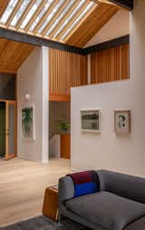 Windows, Wood, and Skylight Window Type Wood slatting above the stairs and the hallway leading to the primary suite lets sunlight reach deeper into the house.