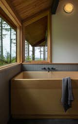 Bath Room, Ceramic Tile Floor, Full Shower, Wall Lighting, Freestanding Tub, and Ceramic Tile Wall A wooden bathtub evokes the couple’s love of Japanese design. The primary suite "feels like an onsen," says Isabel.