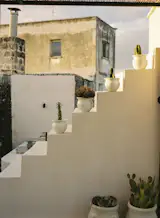 The stairs connect the outdoor kitchen to the lounge and dining area.