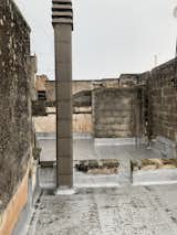 Before: The 150-square-meter rooftop was transformed into three different usable areas: an outdoor kitchen, lounge, and dining area.