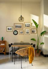 Framed historic photos of the neighborhood hang above the dining room table. "We recently collaborated in the creation of a book about El Cabanyal, which was a really rewarding experience in parallel to our work with the apartment," says David. "The book is about the neighborhood, its history, and the architecture, as well as a practical guide to restore traditional houses."