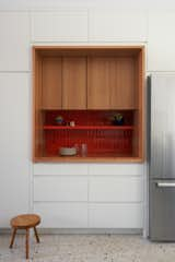 Now, tall storage cabinets surround a niche with Kappa tile from 41Zero42, this time in a brighter hue, combined with a plainsawn white oak frame and Rosso Verona marble counter.