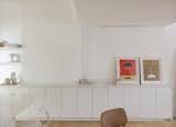 The white cabinets are from Ikea, topped with ABC Stone Afyon White, honed. Artwork by Kristin Texeira sits atop.