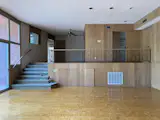 Before: The mezzanine walkway to the garage was removed, as well as some of the wall paneling. The floors were kept and refinished.