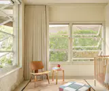 Yuan relocated salvaged windows into new spots. Chair by Eames LCW.