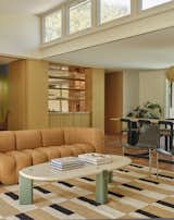 A thread of white oak that's now woven throughout the home starts with a custom bar in the dining room, and wraps the corner into the kitchen.