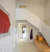 The entry hall had the potential to be the darkest spot in the plan, so Herrero kept the ceiling heights tall, and gave the staircase a sculptural form.