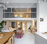 The flex room and living room are tucked under the mezzanine floor with the primary suite.