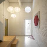 A frosted glass door connects the entry hall to the workshop. "I wanted a simple place that gives me calm,