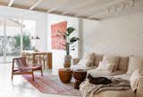In the living room, there's a chair and rug from FÜÜR.