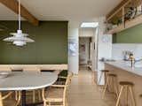 The room has dining chairs by Ton and a pendant light by Louis Poulsen over the table.