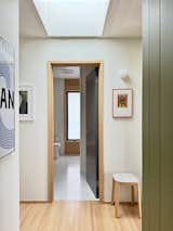 A hall bathroom has plumbing fixtures by Hansgrohe, cabinetry by GLN, and Caesarstone countertops.