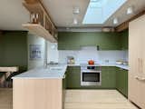 A Bosch stove is now where the sink used to be. The fixtures are by Hansgrohe, rift-sawn red oak cabinetry by GLN, and countertops by Caesarstone.