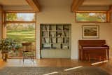 LAMAS filled out an existing niche in the thick wall of the sunroom with a custom built-in for vinyl.