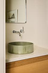 In the powder room, a Pottery Barn mirror hangs over the Mudd Concrete sink and Rubinet faucet.