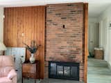 Before: The fireplace was kept, but the wall reworked to remove the obvious electrical plate. "Part of the reason for getting rid of that brick was that it had a giant outlet at eye height,
