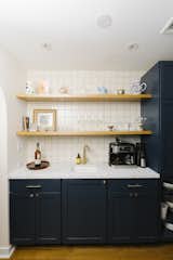 They added an arched opening to the living room, as well as tile and floating shelves to the backsplash.